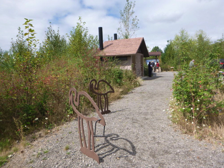 Art work at the parking lot is a bike rack – vault toilets – informational kiosk Art work at the parking lot is a bike rack – vault toilets – informational kiosk